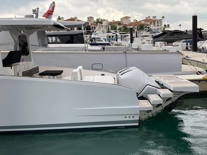 Slide: The Image of 2022 Tesoro T40 Outboard boat docked at a marina with luxury yachts. - 24