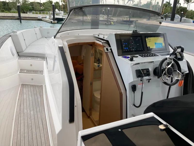 Slide: The Image of 2022 Tesoro T40 Outboard boat interior with modern dashboard and cabin entrance. - 25
