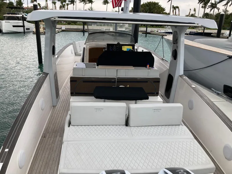 Slide: The Image of 2022 Tesoro T40 Outboard boat docked, featuring spacious deck and modern design. - 26