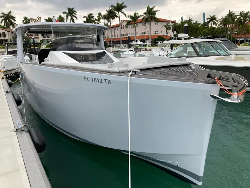 Slide: The Image of 2022 Tesoro T40 Outboard boat docked in marina with palm trees in background. - 4