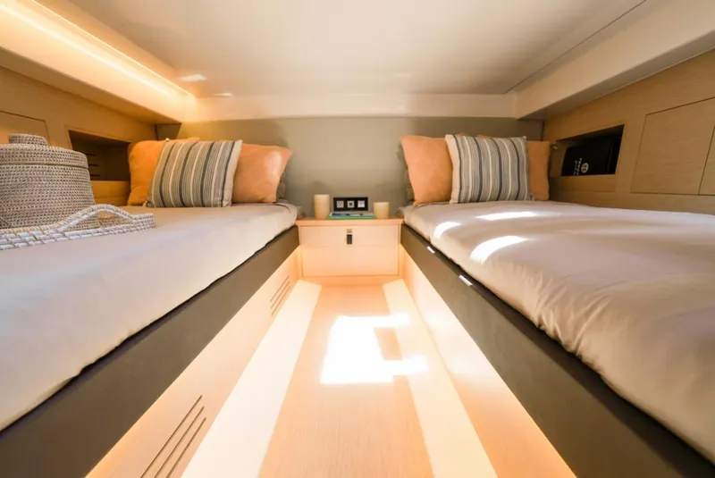 Slide: The Image of 2022 Tesoro T40 Outboard cabin with twin beds and modern interior design. - 9