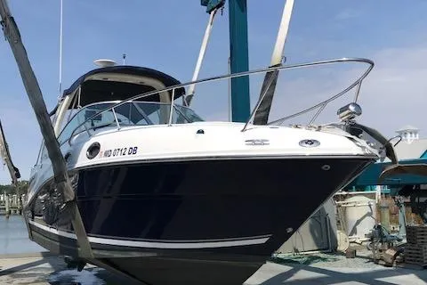Slide: The Image of 2005 Sea Ray 260 Sundancer boat on lift at marina, side view. - 11
