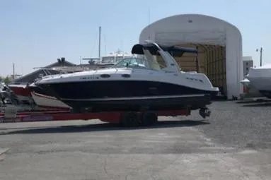 Slide: The Image of 2005 Sea Ray 260 Sundancer boat on trailer in marina storage area. - 12