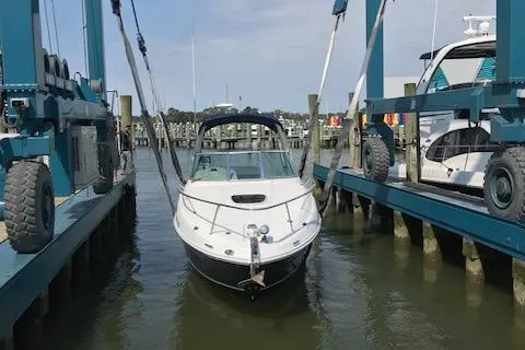 Slide: The Image of 2005 Sea Ray 260 Sundancer boat in marina lift, ready for launch. - 13