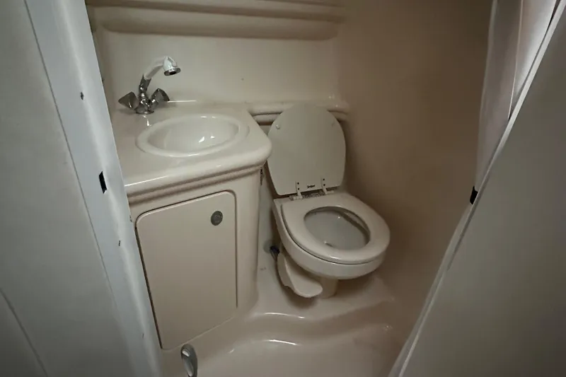 Slide: The Image of Compact bathroom in 2005 Sea Ray 260 Sundancer boat with sink and toilet. - 14