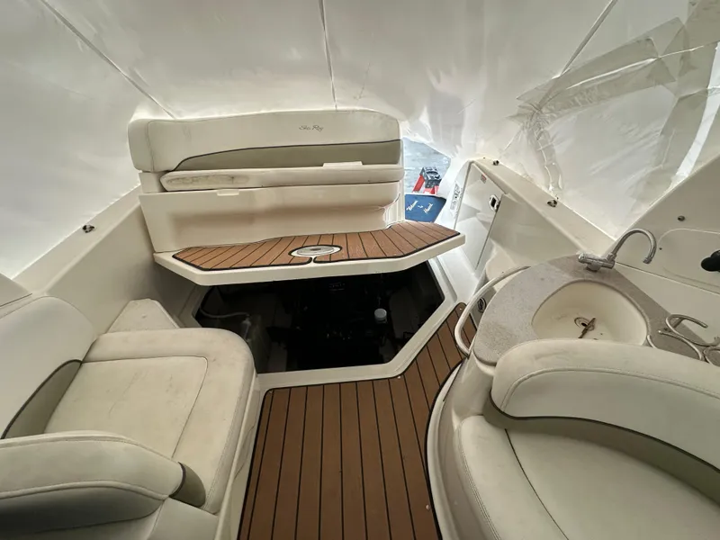 Slide: The Image of 2005 Sea Ray 260 Sundancer interior with seating, table, and sink. - 5