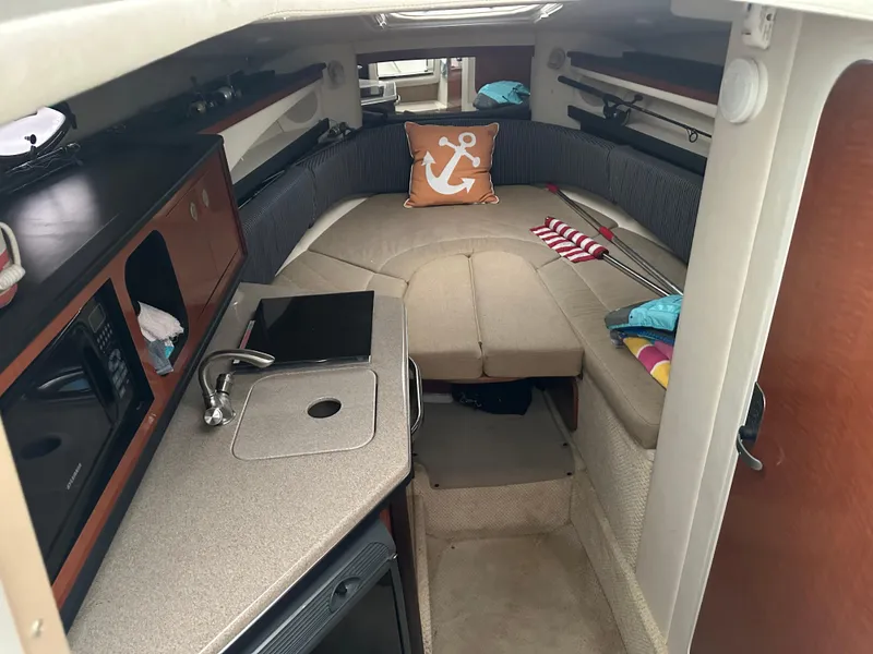 Slide: The Image of 2005 Sea Ray 260 Sundancer cabin interior with kitchenette and seating area. - 8