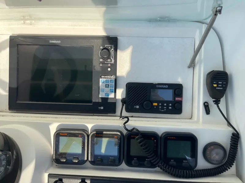 Slide: The Image of Control panel of a 1999 Contender 35 Express Side Console with navigation equipment. - 15