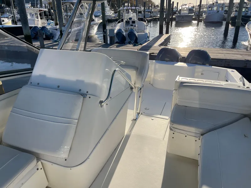 Slide: The Image of 1999 Contender 35 Express Side Console boat interior at marina, with seating and helm. - 16
