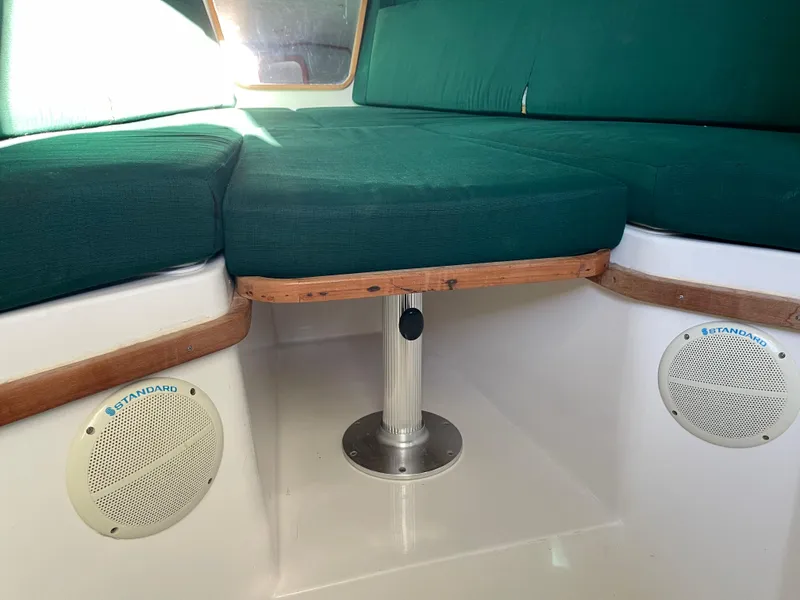 Slide: The Image of 1999 Contender 35 Express Side Console interior with green cushions and built-in speakers. - 31