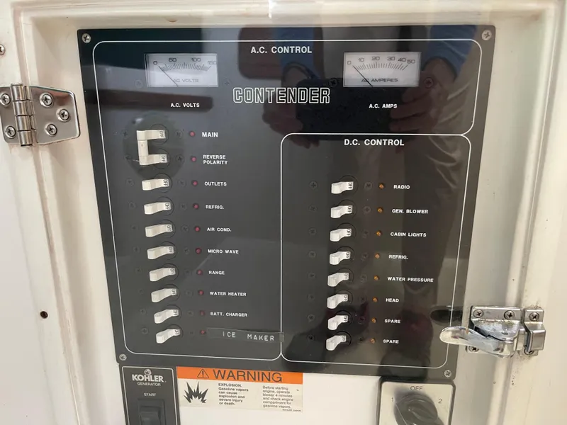 Slide: The Image of Electrical control panel of a 1999 Contender 35 Express Side Console boat. - 38