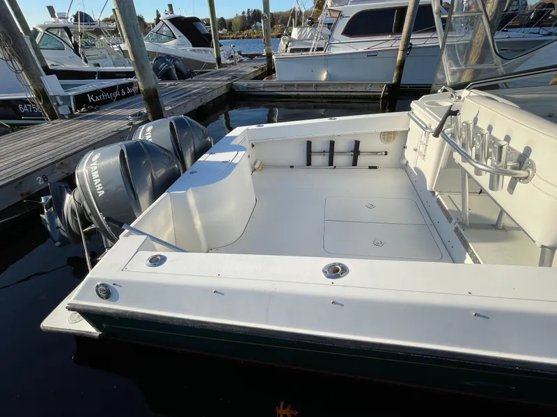 Slide: The Image of 1999 Contender 35 Express Side Console boat docked with Yamaha outboard engines. - 4