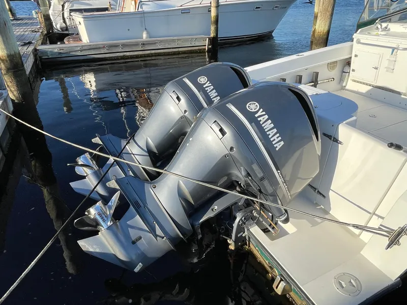 Slide: The Image of Twin Yamaha outboard motors on a 1999 Contender 35 Express Side Console boat. - 8