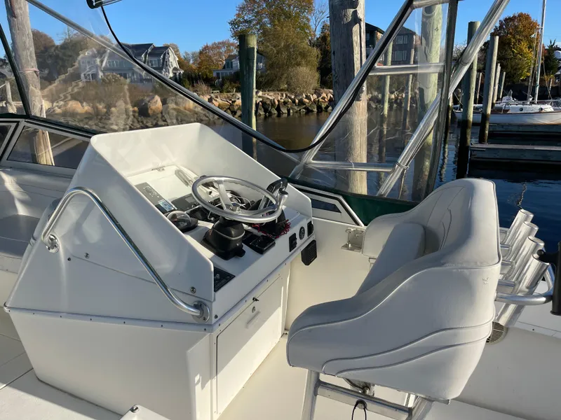 Slide: The Image of 1999 Contender 35 Express Side Console boat interior with steering wheel and seating. - 9