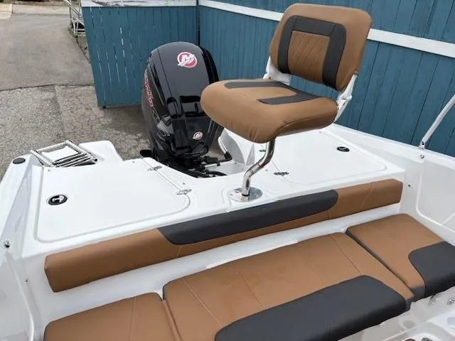 Slide: The Image of 2025 Tahoe 185 S boat with brown seating and powerful outboard motor. - 19