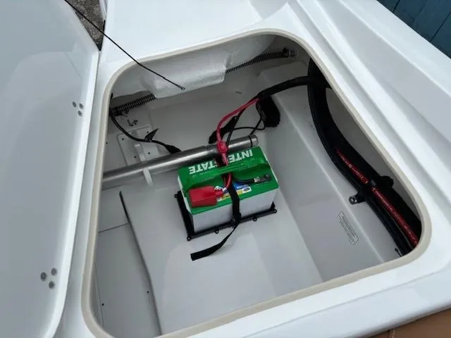 Slide: The Image of Battery compartment of 2025 Tahoe 185 S boat, featuring Interstate battery. - 20
