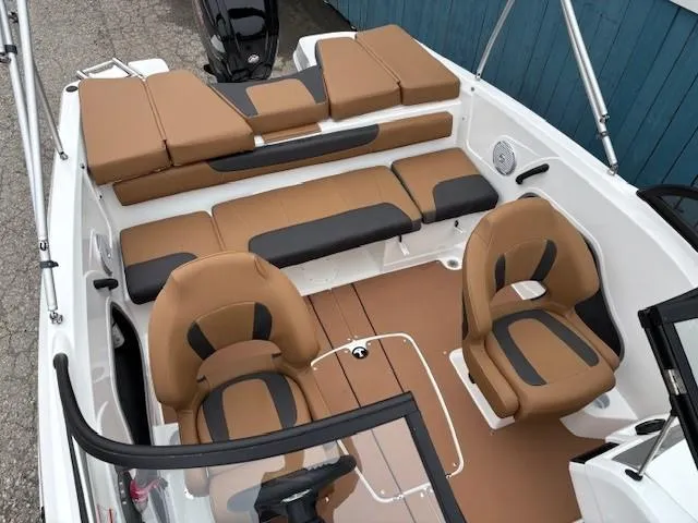 Slide: The Image of 2025 Tahoe 185 S boat interior with tan and black seating, featuring a modern design. - 7