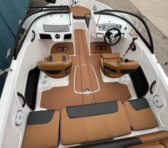 Slide: The Image of 2025 Tahoe 185 S boat interior with tan and black seating, modern dashboard, and steering wheel. - 8