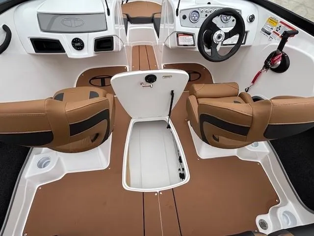 Slide: The Image of 2025 Tahoe 185 S boat interior with brown seats and steering wheel. - 9