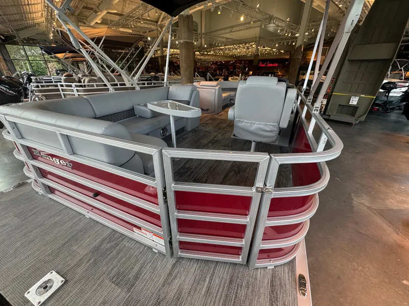 Slide: The Image of 2025 Ranger Reata 220C pontoon boat with red exterior and spacious seating. - 4