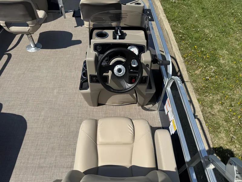 Slide: The Image of 2025 Sun Tracker Bass Buggy 18 DLX boat interior with steering console and seating. - 4