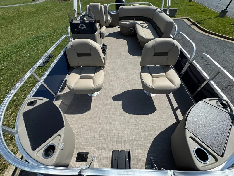 Slide: The Image of 2025 Sun Tracker Bass Buggy 18 DLX pontoon boat interior with beige seating and spacious layout. - 5