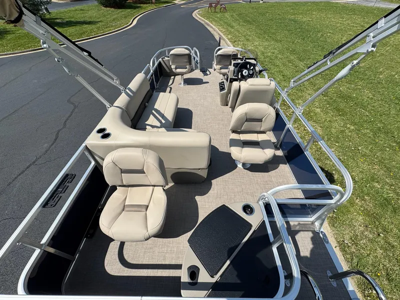 Slide: The Image of 2025 Sun Tracker Bass Buggy 18 DLX pontoon boat with beige seating and spacious deck. - 7