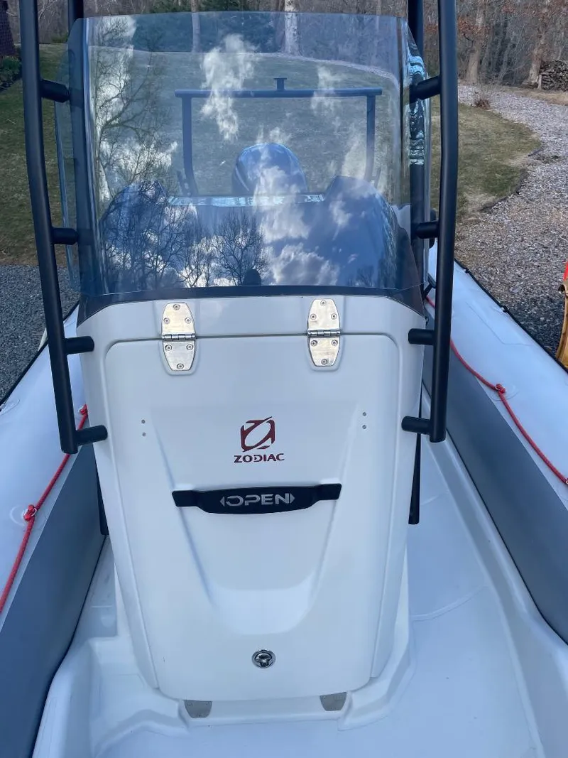 Slide: The Image of 2020 Zodiac Open 6.5 boat with windshield and console, docked outdoors. - 10