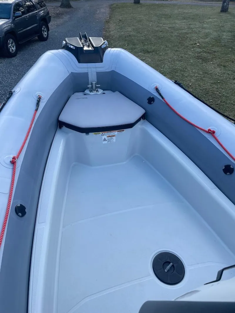 Slide: The Image of 2020 Zodiac Open 6.5 boat interior with red ropes and storage compartment. - 12