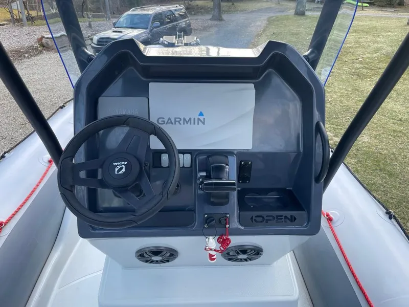 Slide: The Image of 2020 Zodiac Open 6.5 boat console with Garmin navigation system and steering wheel. - 13