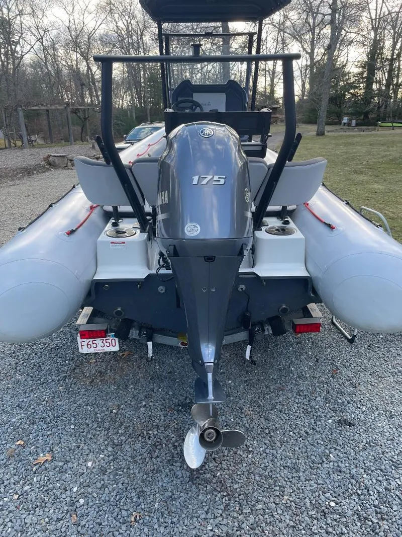 Slide: The Image of 2020 Zodiac Open 6.5 boat with 175 HP engine, parked on gravel. - 16