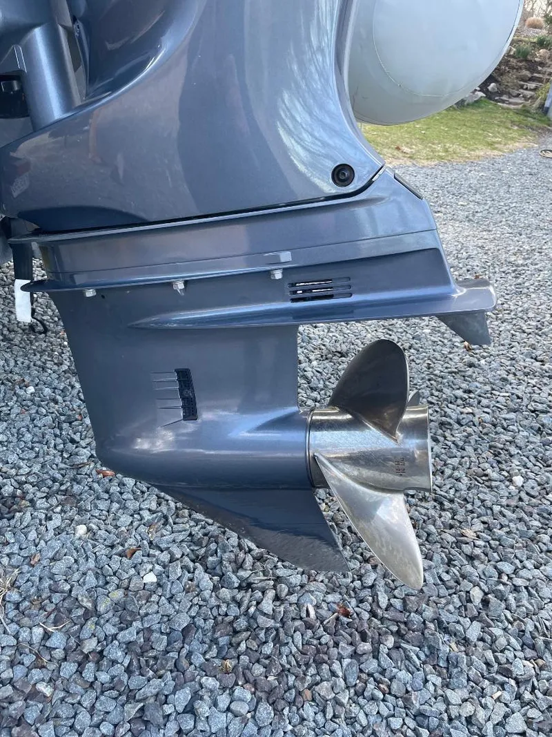 Slide: The Image of 2020 Zodiac Open 6.5 boat motor with stainless steel propeller on gravel surface. - 17