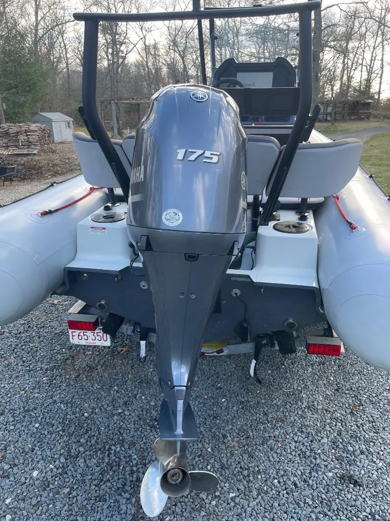 Slide: The Image of 2020 Zodiac Open 6.5 boat with Yamaha 175 engine, parked on gravel. - 18