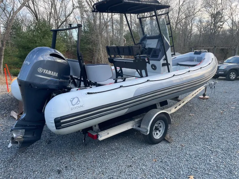 Slide: The Image of 2020 Zodiac Open 6.5 boat with Yamaha engine on a trailer, parked outdoors. - 5