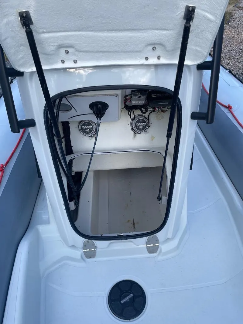 Slide: The Image of Zodiac Open 6.5 boat interior, 2020 model, showing storage compartment and controls. - 9