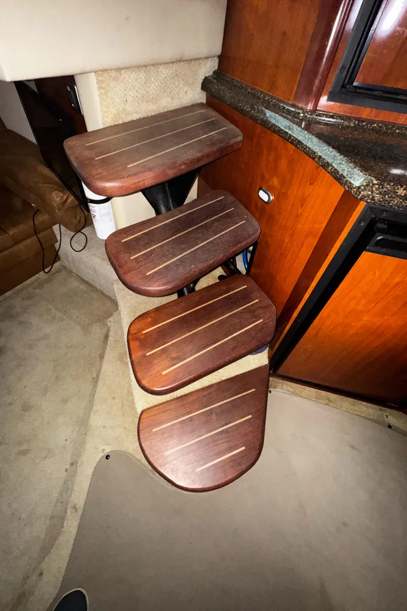 Slide: The Image of Wooden steps inside a 2006 Sea Ray 380 Sundancer yacht, leading to the cabin. - 10