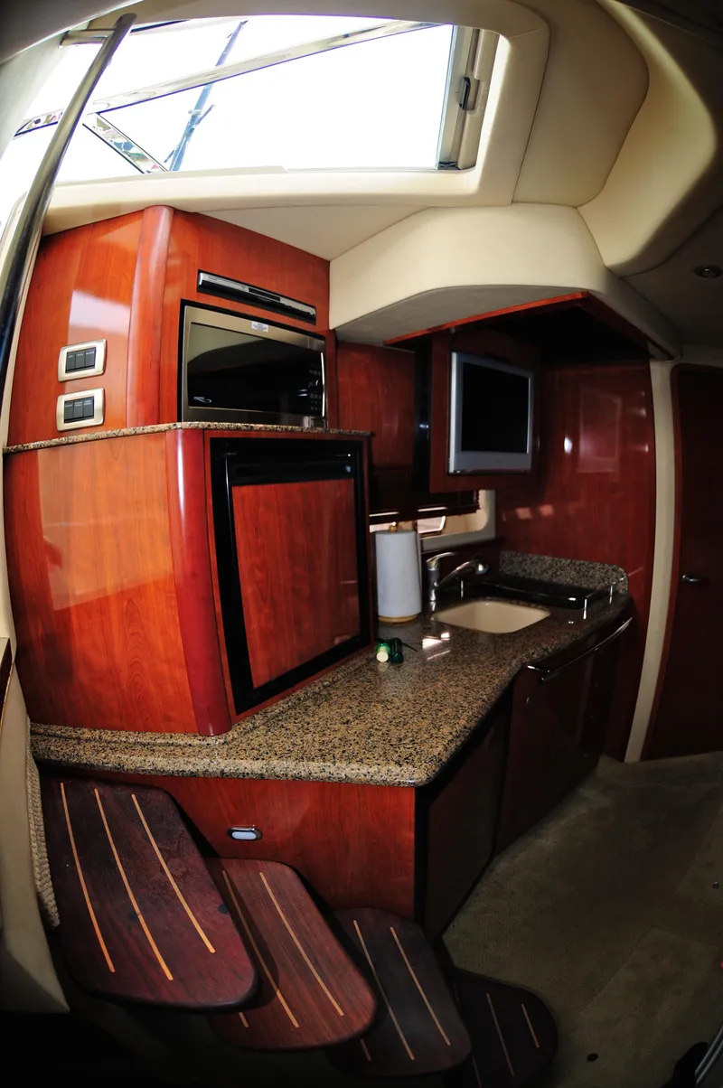 Slide: The Image of Interior of 2006 Sea Ray 380 Sundancer yacht with wood cabinetry and modern amenities. - 12