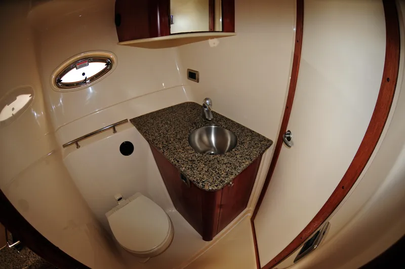 Slide: The Image of Luxurious bathroom in 2006 Sea Ray 380 Sundancer yacht with granite countertop and stainless steel sink. - 14