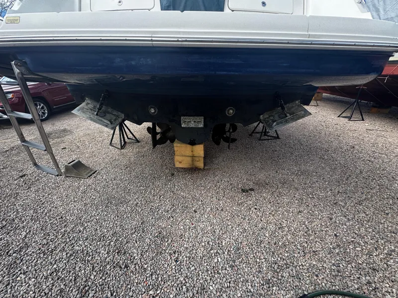 Slide: The Image of 2006 Sea Ray 380 Sundancer boat on gravel, supported by blocks and stands. - 2