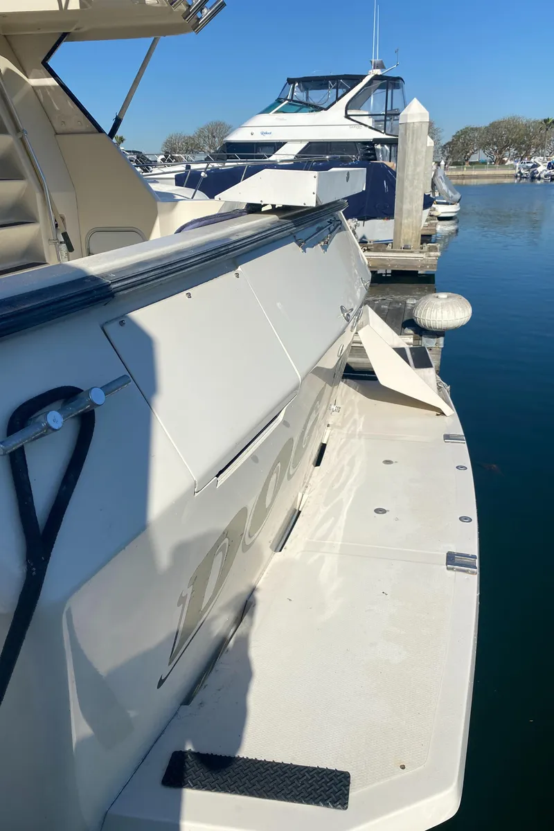 Slide: The Image of 1991 Mainship 41 Convertible yacht docked at marina, sunny day, calm waters. - 11