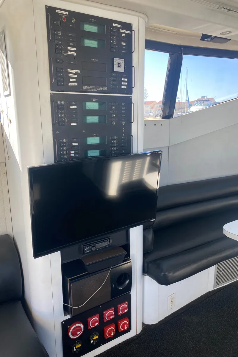 Slide: The Image of Control panel and TV inside 1991 Mainship 41 Convertible yacht. - 14