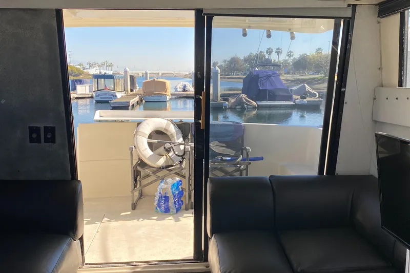 Slide: The Image of Interior view of 1991 Mainship 41 Convertible yacht, overlooking marina through glass doors. - 17