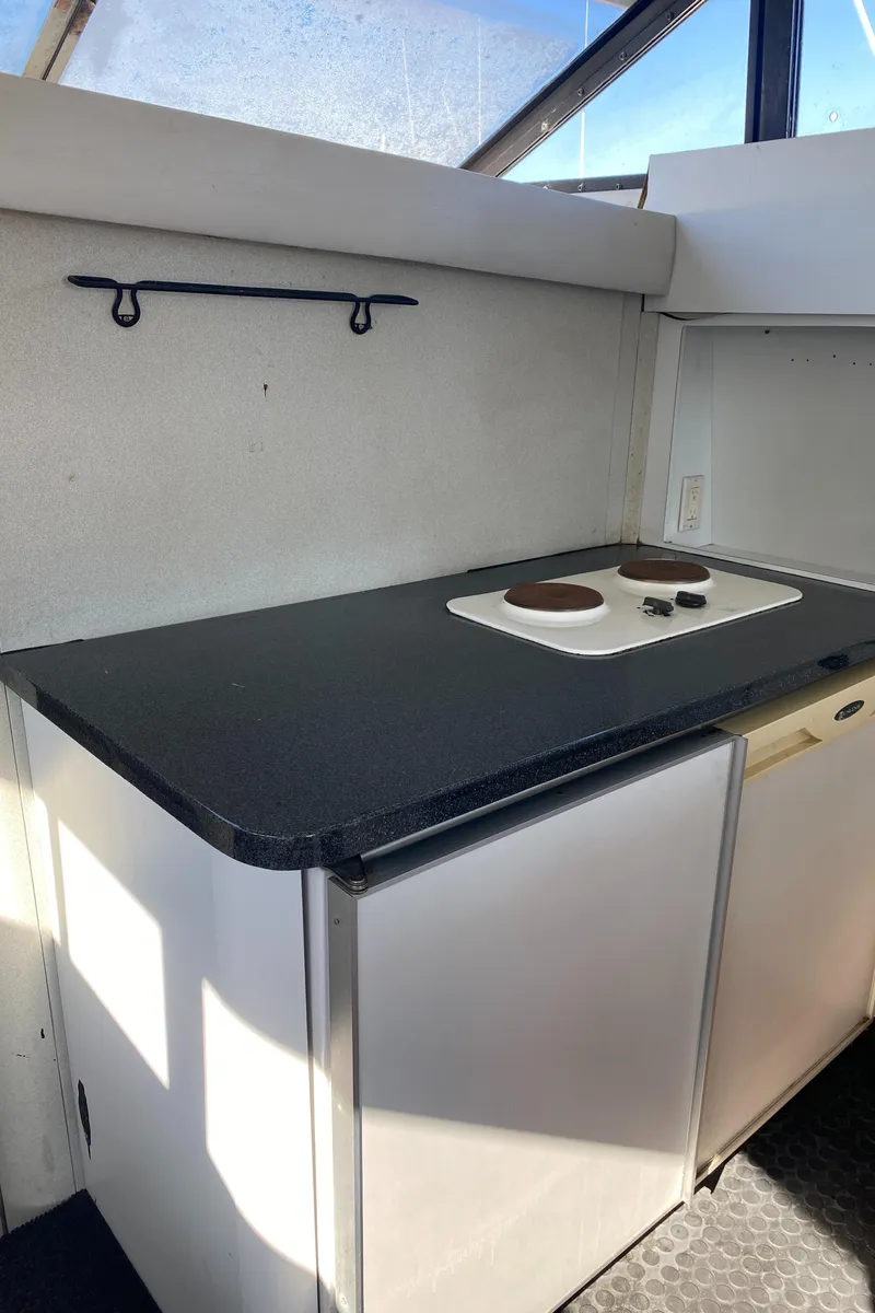 Slide: The Image of 1991 Mainship 41 Convertible yacht kitchen with stove and counter space. - 19