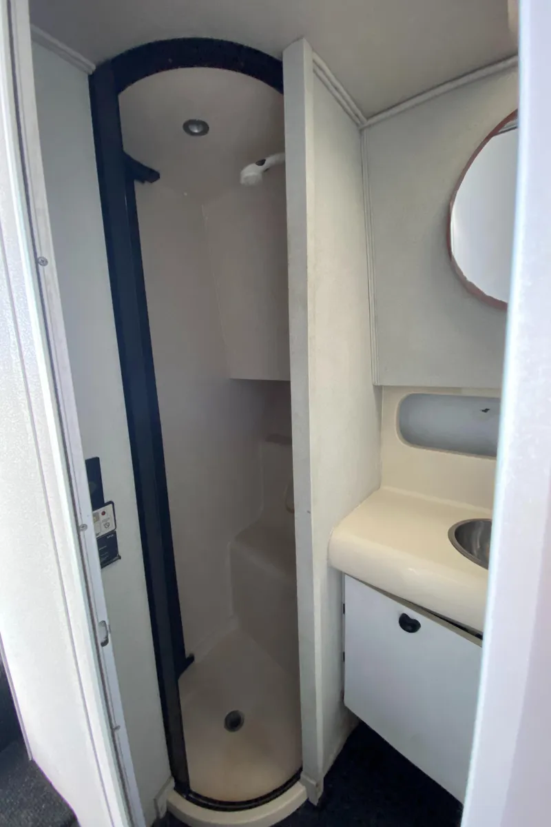 Slide: The Image of 1991 Mainship 41 Convertible bathroom with shower, sink, and mirror. - 25