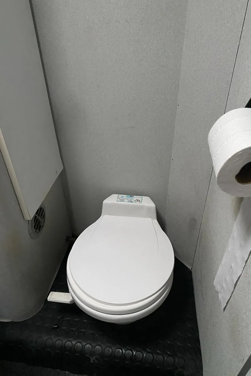 Slide: The Image of Toilet in 1991 Mainship 41 Convertible boat bathroom with toilet paper holder. - 26