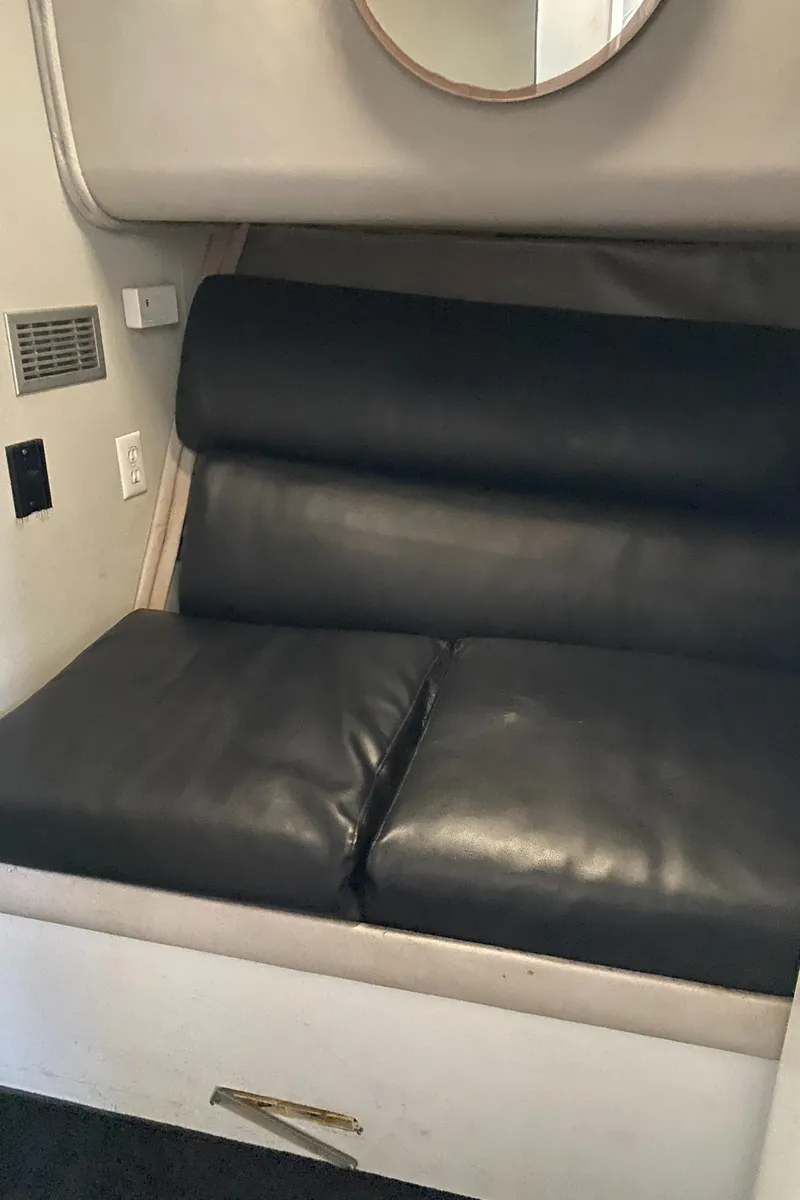 Slide: The Image of 1991 Mainship 41 Convertible interior with black leather seating and modern design elements. - 27