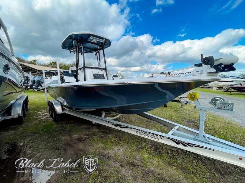 Slide: The Image of 2022 Tidewater 2210 Carolina Bay boat on trailer under cloudy sky. - 0