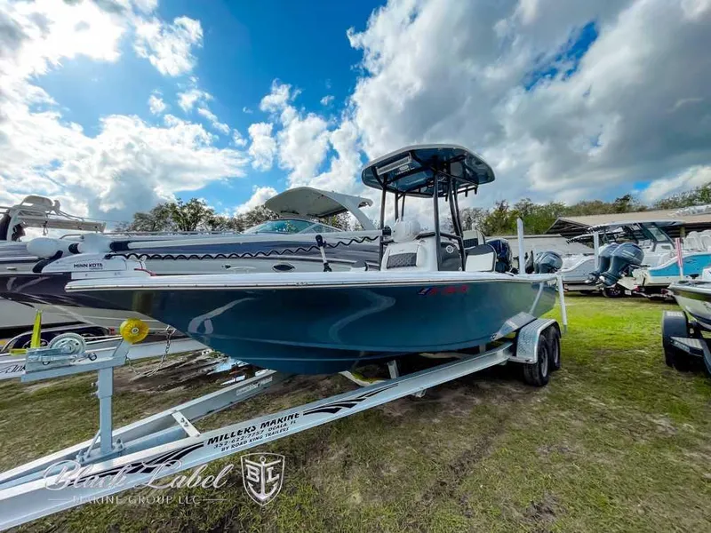 Slide: The Image of 2022 Tidewater 2210 Carolina Bay boat on trailer under cloudy sky. - 1