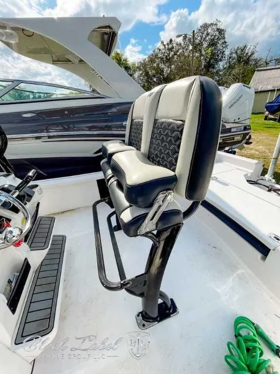 Slide: The Image of 2022 Tidewater 2210 Carolina Bay boat interior with dual black and gray seats. - 8