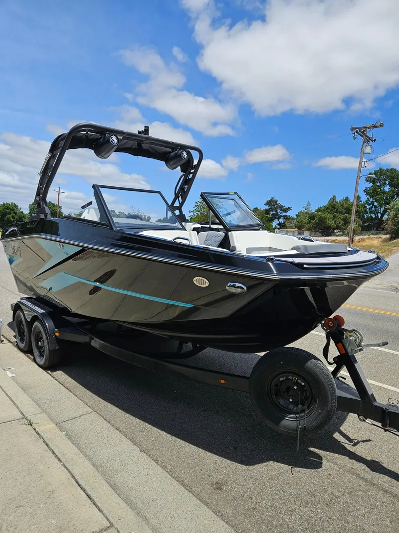 Slide: The Image of 2023 HEYDAY WAKE BOATS H20 on trailer, sleek black design, parked roadside. - 6